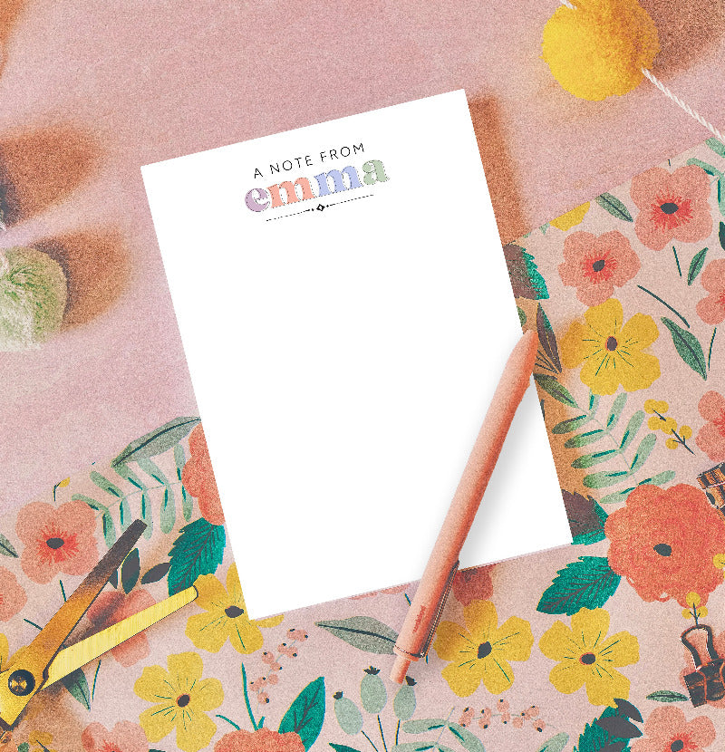 Notepad with 'A Note from Emma' text on a floral background