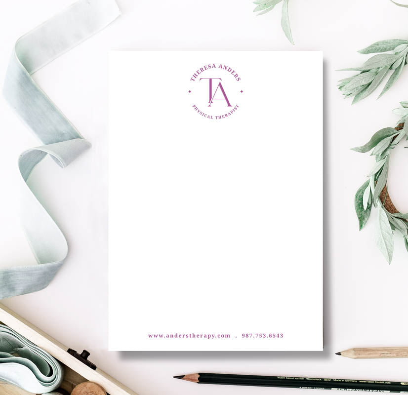 Notebook with a personalized design featuring a logo and text on a white background with greenery.