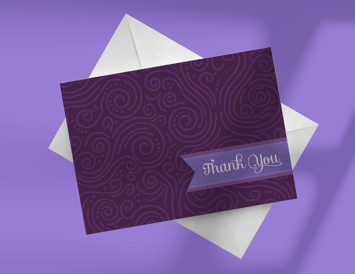 A plum purple note card with a swirl pattern and the words 'Thank You' printed on the front, accompanied by a white envelope.