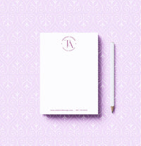 Notebook with a pencil on a purple patterned background